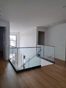 Frameless CH series glass balustrade with black channel and top rail