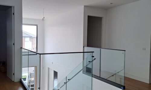 Frameless CH series glass balustrade with black channel and top rail