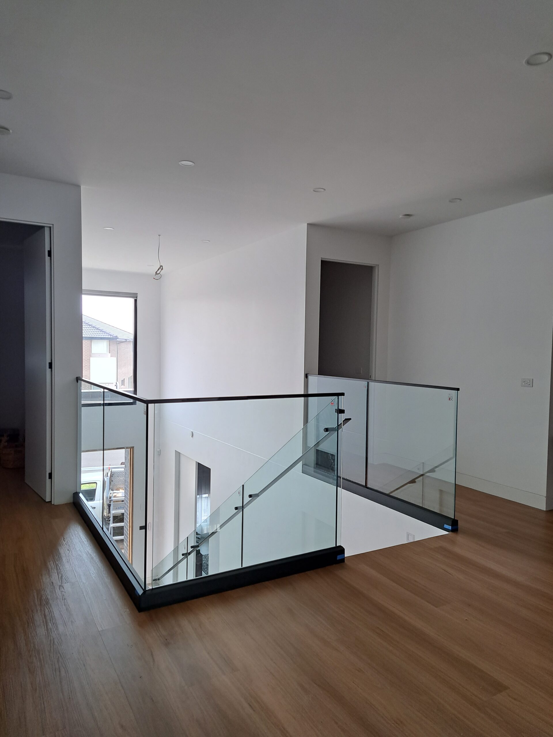 Frameless CH series glass balustrade with black channel and top rail